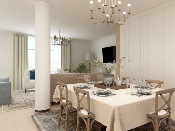 Spacious dining room featuring a large wooden table set for six, surrounded by rustic-style chairs under a modern chandelier, with adjacent cozy living area and neutral color tones. Step into this elegantly appointed dining room that masterfully blends classic charm and contemporary design. The focal point is a large wooden dining table set for six, showcasing fine tableware and glassware, ready for a sophisticated dining experience. The table is surrounded by rustic-style chairs, enhancing the room’s classic appeal, while a modern chandelier with multiple bulbs hangs overhead, providing a contemporary twist. The dining area flows seamlessly into a cozy living space, visible in the background, featuring a plush sofa and tasteful decor, all unified by soothing neutral tones and natural light filtering through large windows. This space exemplifies a perfect blend of functionality and style, ideal for those looking to inspire their own home with a balance of modern amenities and timeless elegance.