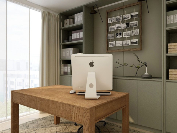 Chic home office featuring an Apple iMac on a wooden desk, surrounded by built-in shelves filled with neatly organized boxes and books, and a unique photo board on the wall, all in a room with a large window. Discover the functionality and style of this chic home office setup, designed to inspire creativity and productivity. Centered in the room is a wooden desk with a modern Apple iMac, an essential for any tech-savvy professional. Surrounding the workspace are built-in shelves that provide ample storage, neatly organized with boxes, files, and books. The wall features a unique photo board filled with black and white images, adding a personal touch and inspiration to the space. Natural light from a large window fills the room, creating a bright and airy atmosphere, ideal for working hours. This home office combines practical storage solutions with a stylish design, making it a perfect example for those looking to create a functional yet aesthetically pleasing work environment in their home.