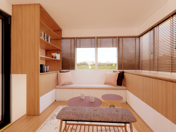 Cozy bedroom corner transformed into a reading nook with wooden shelving and blinds, overlooking an open landscape. This image captures a snug and inviting corner of a bedroom designed as a reading nook. The warm wooden shelving seamlessly integrates with the window seat, inviting one to sit down with a book. The wooden blinds control the influx of natural light, creating a soft, ambient glow that highlights the simplicity and comfort of the space. The earth-toned cushions add a touch of softness and contrast beautifully with the wooden textures. The room’s decor is minimalistic, focusing on clean lines and functionality without sacrificing warmth and homeliness. A simple, patterned rug under the coffee table adds a dash of personality to the space, and the open window offers a tranquil view that encourages relaxation and contemplation.