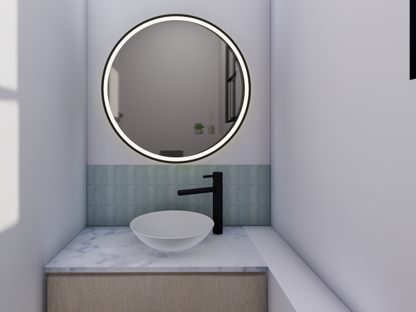 A minimalist bathroom vanity featuring a round, illuminated mirror, a marble countertop, and a white vessel sink complemented by a matte black faucet against a teal tile backsplash. This elegantly simple bathroom vanity is the epitome of minimalist design, featuring a pristine white vessel sink that sits atop a marble countertop. The teal backsplash tiles add a splash of serene color, harmonizing with the matte black faucet. A round mirror with backlighting not only serves a functional purpose but also adds a modern touch with its ambient glow, creating a peaceful atmosphere that soothes and rejuvenates. This setup exemplifies how less can indeed be more, by combining functionality with a clean, uncluttered aesthetic.